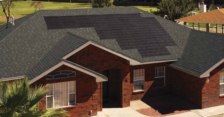 Solar shingles on the roof of a red brick home