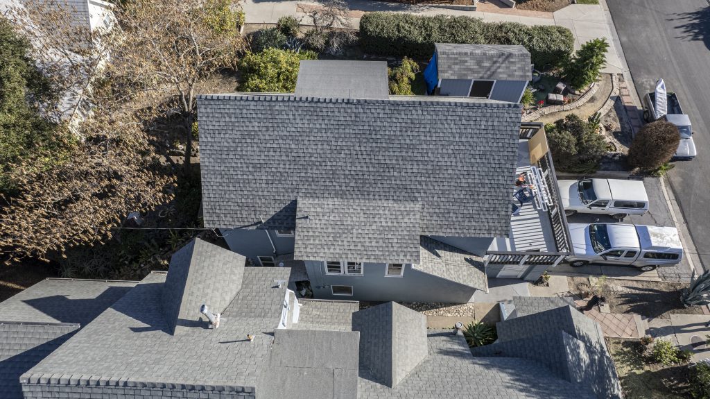 Residential home with a new asphalt roof, ideal for illustrating how long does an asphalt roof last with proper care.